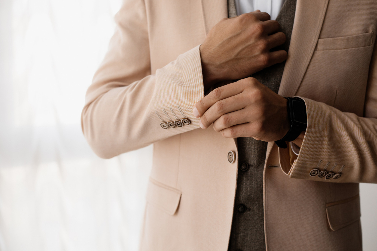 stylish-man-adjusts-sleeve-his-jacket